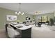 Bright open-concept living and dining room with neutral colors and sliding glass doors to lanai at 5920 80Th N St # 103, St Petersburg, FL 33709
