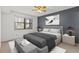 Relaxing main bedroom featuring a ceiling fan, window, and stylish decor at 5920 80Th N St # 103, St Petersburg, FL 33709