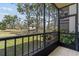 View of a peaceful screened patio overlooking the expansive lawn and mature trees at 5920 80Th N St # 103, St Petersburg, FL 33709