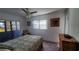 Cozy bedroom with a ceiling fan, natural light, and a comfortable bed and furnishings at 5967 Terrace Park N Dr # 101, St Petersburg, FL 33709