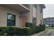 Condo exterior featuring a charming doorway framed by a neatly trimmed hedge at 5967 Terrace Park N Dr # 101, St Petersburg, FL 33709