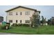 Exterior shot of a well-maintained two-story condo building on a lush lawn at 5967 Terrace Park N Dr # 101, St Petersburg, FL 33709