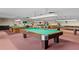 Community game room featuring multiple pool tables with carpeted floor, offering a recreational space at 5967 Terrace Park N Dr # 101, St Petersburg, FL 33709