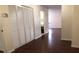 Hallway with dark hardwood floors, neutral colored walls, and large closet at 5967 Terrace Park N Dr # 101, St Petersburg, FL 33709