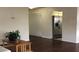 Living room featuring dark wood floors, neutral walls, and stainless steel refrigerator visible from kitchen at 5967 Terrace Park N Dr # 101, St Petersburg, FL 33709