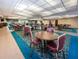 Community meeting room with multiple tables and chairs for events and social gatherings at 5967 Terrace Park N Dr # 101, St Petersburg, FL 33709