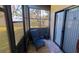 Enclosed patio with sliding glass doors and a blue chair with a view of the outdoors at 5967 Terrace Park N Dr # 101, St Petersburg, FL 33709