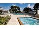 Resort-style pool area with spacious deck and hot tub, perfect for relaxation and recreation at 5967 Terrace Park N Dr # 101, St Petersburg, FL 33709