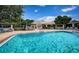 A spacious community pool with lounge seating offers a relaxing outdoor experience for residents and guests at 5967 Terrace Park N Dr # 101, St Petersburg, FL 33709