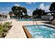 Community pool and spa area with lounge chairs and well-maintained landscaping, perfect for relaxation at 5967 Terrace Park N Dr # 101, St Petersburg, FL 33709