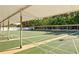 Community shuffleboard courts, covered and ready for play, surrounded by mature trees at 5967 Terrace Park N Dr # 101, St Petersburg, FL 33709