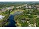 Expansive aerial shot showcasing the property's waterfront location with surrounding trees and neighboring homes at 6501 Barcellona Rd, Land O Lakes, FL 34637