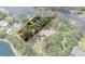 Aerial view with property line showing home's location surrounded by lush greenery and waterfront access at 6501 Barcellona Rd, Land O Lakes, FL 34637