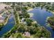High angle view of the property highlighting its location near a lake and surrounding neighborhoods at 6501 Barcellona Rd, Land O Lakes, FL 34637