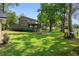 Spacious backyard with a fire pit, porch, picnic table, and mature trees creating a relaxing outdoor oasis at 6501 Barcellona Rd, Land O Lakes, FL 34637