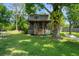 Beautiful backyard with a covered porch, tree swing, hammock, and lush greenery, perfect for relaxation and recreation at 6501 Barcellona Rd, Land O Lakes, FL 34637