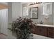 Bright bathroom with double sinks, granite countertops, and a decorative plant, creating a relaxing and inviting atmosphere at 6501 Barcellona Rd, Land O Lakes, FL 34637