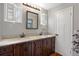 Bathroom with double sinks, granite countertops, and wooden cabinetry, offering a blend of style and functionality at 6501 Barcellona Rd, Land O Lakes, FL 34637