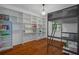 This bedroom features built-in shelving, wood floors and a metal bunk bed at 6501 Barcellona Rd, Land O Lakes, FL 34637
