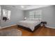 Bright bedroom featuring a comfortable bed with hardwood flooring and a window creating a peaceful and inviting space at 6501 Barcellona Rd, Land O Lakes, FL 34637