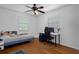 This bedroom features hardwood floors, a ceiling fan and a light blue accent wall at 6501 Barcellona Rd, Land O Lakes, FL 34637