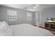 Comfortable bedroom featuring a cozy bed, natural lighting, and hardwood floors at 6501 Barcellona Rd, Land O Lakes, FL 34637