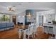Open-concept dining area with modern lighting and seating adjacent to the living room and kitchen at 6501 Barcellona Rd, Land O Lakes, FL 34637