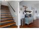 Inviting entryway featuring wood stairs, a coffee station and hardwood flooring, creating a warm and welcoming ambiance at 6501 Barcellona Rd, Land O Lakes, FL 34637