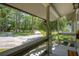 Inviting front porch view with a spacious driveway lined with mature trees and a serene outdoor atmosphere at 6501 Barcellona Rd, Land O Lakes, FL 34637