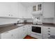 Clean kitchen features white cabinetry, backsplash, and modern appliances at 6501 Barcellona Rd, Land O Lakes, FL 34637