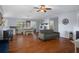 Open-concept living room with wood floors, fireplace, and abundant natural light at 6501 Barcellona Rd, Land O Lakes, FL 34637