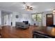 Cozy living room featuring fireplace, wood floors, and ample natural light at 6501 Barcellona Rd, Land O Lakes, FL 34637