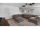 Relax in the living room featuring a ceiling fan, a large sectional sofa, and hardwood flooring at 6501 Barcellona Rd, Land O Lakes, FL 34637