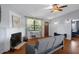 Comfortable living room with fireplace, hardwood floors, and view of entryway at 6501 Barcellona Rd, Land O Lakes, FL 34637