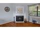 Cozy living room with hardwood floors, fireplace, and natural light from the window at 6501 Barcellona Rd, Land O Lakes, FL 34637
