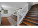 Living room and stairs with wood floors, tan sofa, and white walls at 6501 Barcellona Rd, Land O Lakes, FL 34637