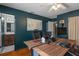 This office features wood floors, dark blue walls and a long wood desk with office monitors at 6501 Barcellona Rd, Land O Lakes, FL 34637