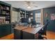 Spacious home office featuring built-in shelving, wood floors, and ample desk space at 6501 Barcellona Rd, Land O Lakes, FL 34637