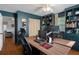 A home office featuring two desks, built-in storage and shelving, providing a comfortable workspace at 6501 Barcellona Rd, Land O Lakes, FL 34637