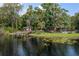 Picturesque waterfront property with a private dock, shed, and lush greenery, offering serene lakeside living at 6501 Barcellona Rd, Land O Lakes, FL 34637