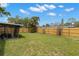 Lush backyard with a new wooden fence and cozy screened patio area at 6620 Del Prado Ter, New Port Richey, FL 34652