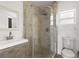 Updated bathroom features a glass-enclosed shower with tiled walls and modern fixtures at 6620 Del Prado Ter, New Port Richey, FL 34652