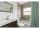 Updated bathroom features a wood-look tiled shower and vanity with modern fixtures at 6620 Del Prado Ter, New Port Richey, FL 34652