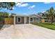 Inviting single-story home featuring a covered entry and a spacious driveway at 6620 Del Prado Ter, New Port Richey, FL 34652