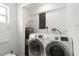 This laundry room features a modern washer and dryer and a water heater at 6620 Del Prado Ter, New Port Richey, FL 34652