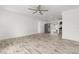 Spacious living room with wood-look tile flooring, flowing into the open kitchen area at 6620 Del Prado Ter, New Port Richey, FL 34652