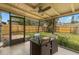 The screened in patio features an outdoor dining table and view of the back yard at 6620 Del Prado Ter, New Port Richey, FL 34652
