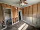 A bedroom with hardwood floors awaiting remodel, with two entrances and a ceiling fan at 6710 Hibiscus S Ave, South Pasadena, FL 33707