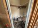 Walk-in closet, ready for renovation, equipped with hanging rack and access to mechanicals at 6710 Hibiscus S Ave, South Pasadena, FL 33707