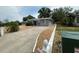 View of the concrete driveway leading to a single-story home with gravel landscaping at 6710 Hibiscus S Ave, South Pasadena, FL 33707